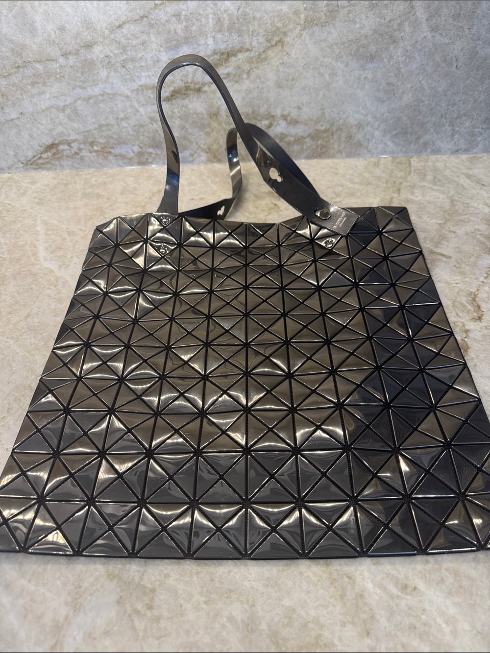 ISSEY Miyake Geometric Tote Bag in silver with black background